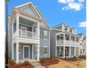 Gray two-story home with front porch and landscaping at 9228 Kitchin Farms Way # 412, Wake Forest, NC 27587