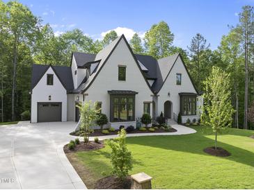 Stunning traditional two-story home with a well-manicured lawn and elegant landscaping at 7621 Falls Creek Ln, Raleigh, NC 27614
