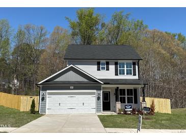 Charming two-story home with a gray-and-white color scheme, a two-car garage, and a well-manicured lawn at 85 Shenandoah Ct, Clayton, NC 27520
