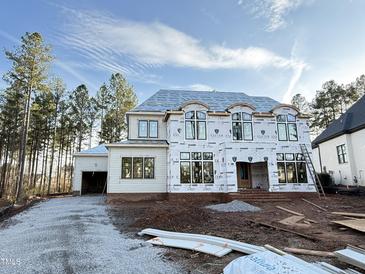 Two-story home under construction with large windows, gravel driveway, and frame showing at 2728 Trifle Ln, Wake Forest, NC 27587