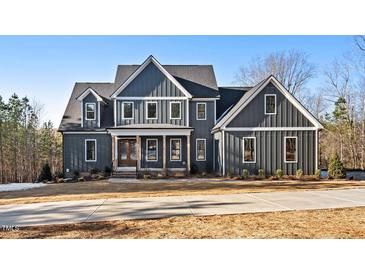 Two story home with gray siding, white accents, and a long driveway at 406 Terry Rd, Hillsborough, NC 27278