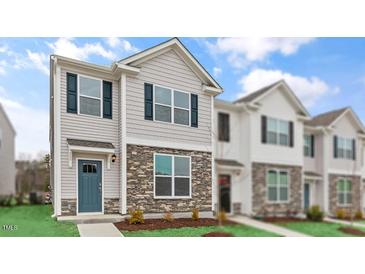 Charming two-story home with stone accents and a welcoming blue front door at 543 Old Battle Bridge Rd, Wendell, NC 27591