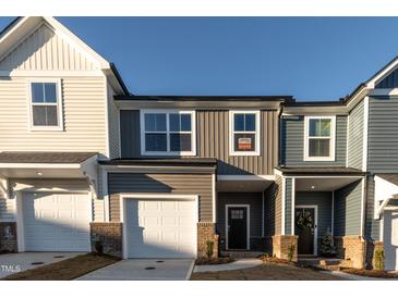 Charming townhome featuring a two-car garage and appealing exterior color scheme at 569 Marthas Vw Way, Wake Forest, NC 27587
