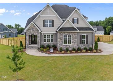 Beautiful new construction home featuring a landscaped yard and stone and shingle design at 25 Cotton Fields Ln # 29, Fuquay Varina, NC 27526