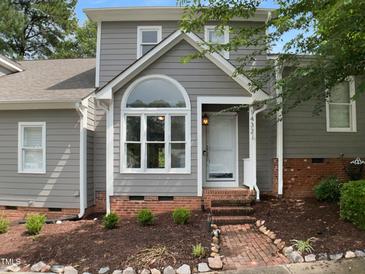 Charming home featuring a unique arched window and well-maintained landscaping at 1432 Quarter Pt, Raleigh, NC 27615