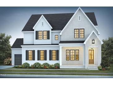 Charming two-story home featuring a mix of brick and white siding, complemented by black shutters and a well-maintained lawn at 162 Gaines Trail, Pittsboro, NC 27312