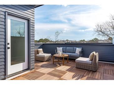 Inviting rooftop deck with stylish outdoor seating, perfect for relaxing and entertaining with beautiful views at 602 Rocky Knob Ct, Raleigh, NC 27601