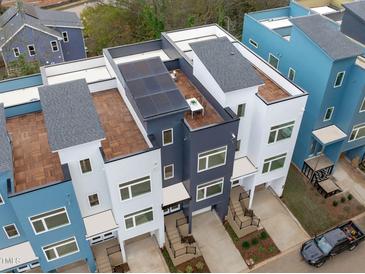 Modern townhomes featuring rooftop decks and contemporary exteriors provide luxurious urban living at 610 Rocky Knob Ct, Raleigh, NC 27601