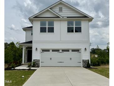 Charming two-story home featuring a two-car garage and stylish white siding at 156 Southern Estates Dr, Sanford, NC 27330