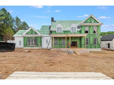 Two-story home featuring green building wrap on the exterior walls under construction at 4812 Parker Meadow Dr, Raleigh, NC 27614
