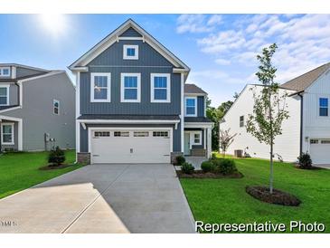 Two-story home with gray siding, white trim, and a two-car garage at 141 Benson Village Dr # 76P, Benson, NC 27504