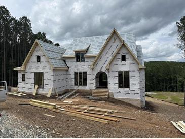 New home construction featuring large windows and archway on a wooded lot at 37 Green Turtle Ln, Pittsboro, NC 27312