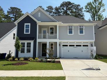 Charming two-story home featuring a balcony, gray siding, black accents, and a well-maintained lawn at 9140 Dupree Meadow Dr # 9, Angier, NC 27501