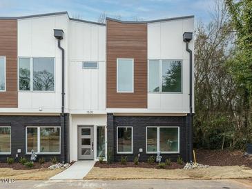 Modern townhome with a unique facade featuring mixed textures and black brick accents at 1535 Urban Trace Ln, Raleigh, NC 27608