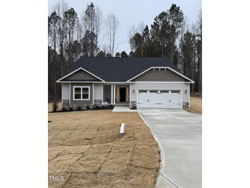 Newly constructed home with a two-car garage and landscaped yard at 60 Lemon Drop Ln, Franklinton, NC 27525