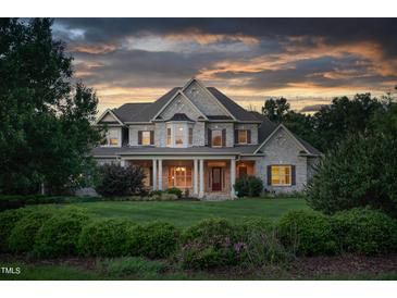 Brick two-story house with a large front porch and manicured lawn at 6366 Lineberry Rd, Liberty, NC 27298