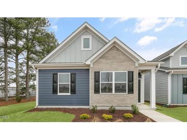 Charming single-story home featuring a mix of brick and siding, and a well-manicured lawn at 791 Washington St, Fuquay Varina, NC 27526