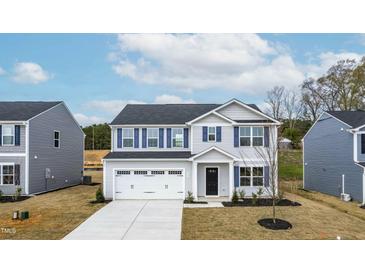 Charming two-story home with blue shutters and a two-car garage, set against a bright sky at 331 Tormore Dr, Sanford, NC 27330