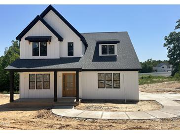 New two-story home features a modern farmhouse design with a black roof and clean white siding at 103 Slocum Dr, Wendell, NC 27591