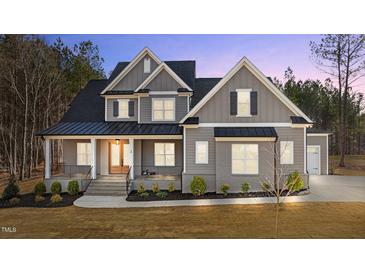 Charming two-story home with a welcoming front porch, complemented by a meticulously landscaped yard at 30 Chestnut Oak Dr, Youngsville, NC 27596