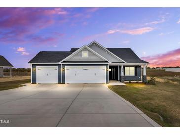 Beautiful single-Gathering home featuring a spacious driveway, two-car garage, and classic architectural details at 208 Hillwood Dr, Sanford, NC 27332
