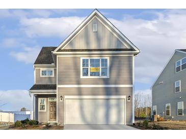 Charming two-story home with gray siding, white trim, and a two-car garage showcasing an available sign at 573 Highview Drive Dr, Benson, NC 27504