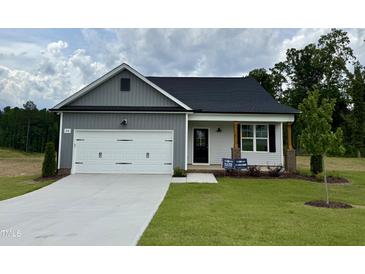 Charming single-Gathering home boasts a well-manicured lawn and a welcoming two-car garage at 234 Danube Dr, Zebulon, NC 27597