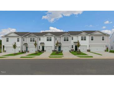 New townhome community with attached garages and well-manicured lawns at 160 Perseus St, Angier, NC 27501