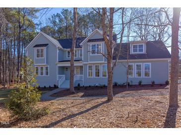 Two story light blue house with white accents and landscaping at 8780 Old Nc 86, Chapel Hill, NC 27516