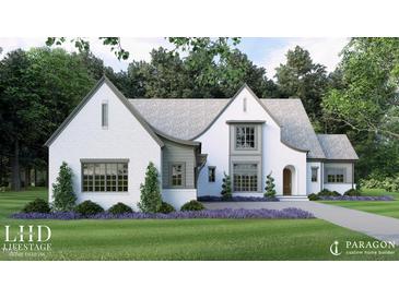 Charming white brick home featuring a curved roofline, manicured lawn and mature trees creating beautiful curb appeal at 791 Chapel Ridge Dr, Pittsboro, NC 27312