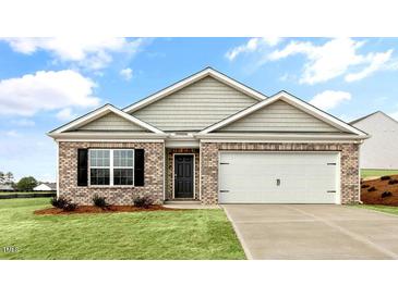 Charming single-Gathering home with brick facade, well-maintained lawn, and an attached two-car garage at 3604 Drafton Dr, Raleigh, NC 27610