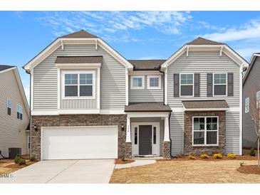 Beautiful two-story home with gray siding, stone accents, and a two-car garage at 134 Black Walnut Dr # 205, Garner, NC 27529