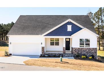 Charming single-Gathering home featuring a two-car garage and a welcoming front porch with stone accents at 818 Barbour Farm Ln, Four Oaks, NC 27524