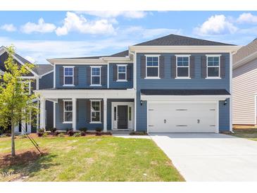 Charming two-story home with a manicured lawn and a two-car garage, perfect for Gathering living at 119 Augusta Pond Way # 147, Raleigh, NC 27603