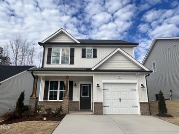 Two-story house with white siding, dark accents, and a two-car garage at 149 Greenview St, Clayton, NC 27520