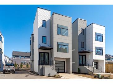 Modern townhomes with clean lines, mixed materials, and private garages create a stylish curb appeal at 227 Woodsborough Pl, Raleigh, NC 27601