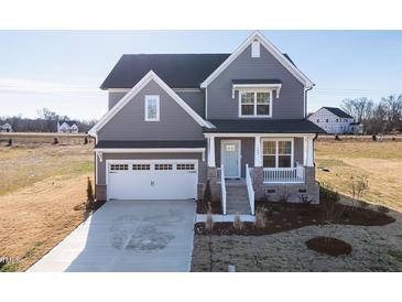 Two-story gray house with white garage door and landscaping at 103 W Star Foal Ln, Wendell, NC 27591