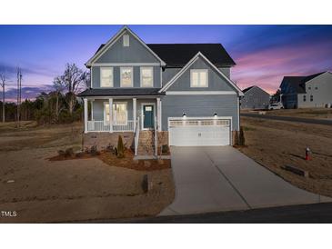 Charming two-story home with a covered porch and attached two-car garage at 22 Belmont Stakes Ln, Wendell, NC 27591