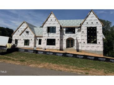 View of construction site of home with exterior weather barrier covering the unfinished facade at 9105 Overlook Crest Dr, Wake Forest, NC 27587