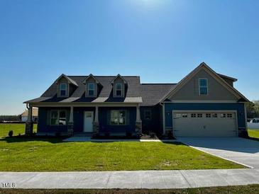 Inviting single-Gathering home featuring a two-car garage, well-maintained lawn, and a classic architectural design at 981 Olive Branch Dr, Smithfield, NC 27577