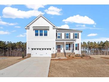 Beautiful two-story home featuring an attached two-car garage, well-kept lawn and landscaped front yard at 100 Bold Dr, Youngsville, NC 27596