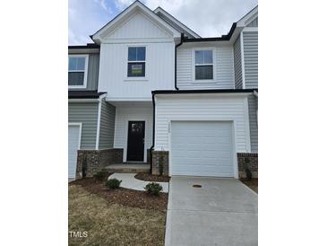 Charming townhome with attached garage, neutral siding, and inviting entryway at 1345 Bessie Ct, Wake Forest, NC 27587