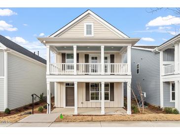Charming two-story home featuring a double stacked porch, neutral siding, and white trim at 9237 Kitchin Farms Way # 429, Wake Forest, NC 27587