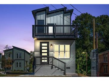 Modern two-story home boasts a balcony, clean lines, and a stylish gray brick facade at 2401 E Main St, Durham, NC 27703