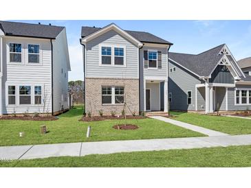 Charming two-story home with a landscaped yard and covered front entrance at 733 Portland Rose Dr, Knightdale, NC 27545