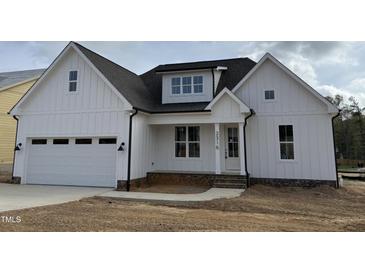 Charming white two-story home featuring an attached garage and a welcoming front porch at 2316 Eagle Shot Ct # 21, Fuquay Varina, NC 27526
