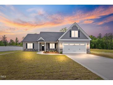 Beautiful home exterior with manicured lawn and modern gray color at 167 Thistle Ct, Sanford, NC 27332
