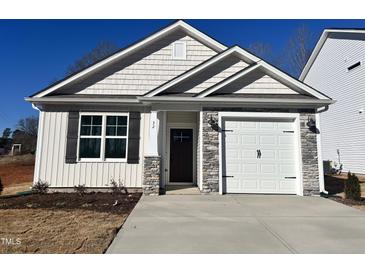 Craftsman style home with stone accents and a two-car garage at 32 S Mistflower St, Clayton, NC 27520