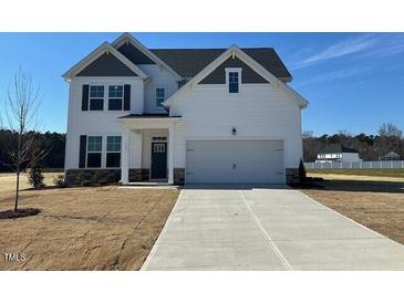 Beautiful two-story home with a classic white exterior and well-manicured lawn at 120 Wild Turkey Way, Lillington, NC 27546