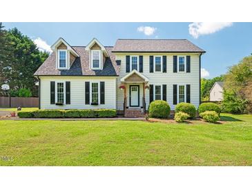 Charming two-story home featuring a manicured lawn, dormer windows, and black shutter accents at 135 Deep Creek, Rougemont, NC 27572